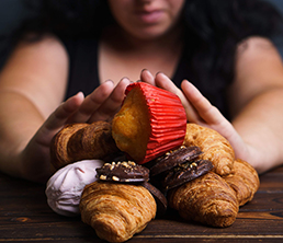 Sugar addiction, nutrition choices, motivation and healthy lifestyle. Cropped portrait of overweight woman refusing sweet food