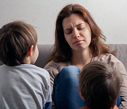 Woman Mom Is Tired In Depression And Children Are Boys. Woman mom is tired in depression and children are boys.